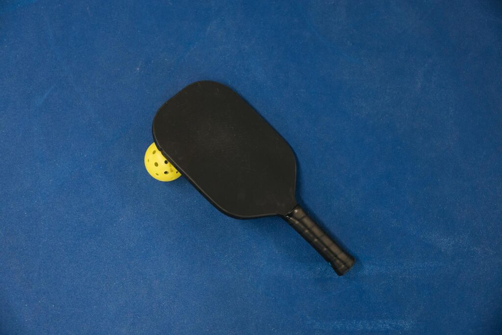 A pickleball racket and ball